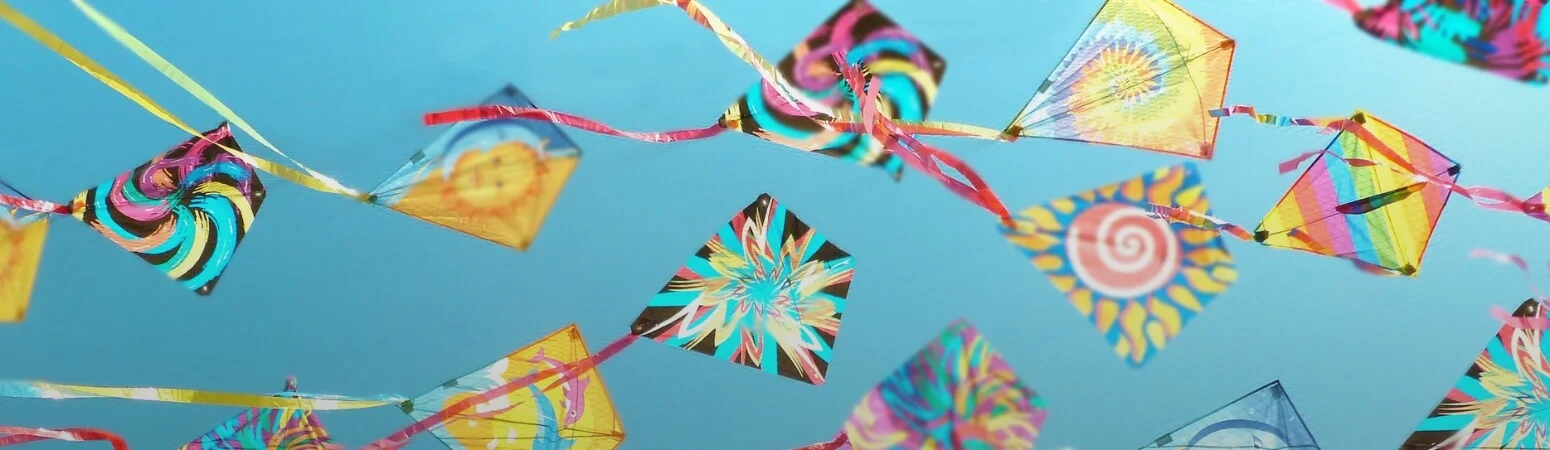 A sky filled with multi-coloured kites